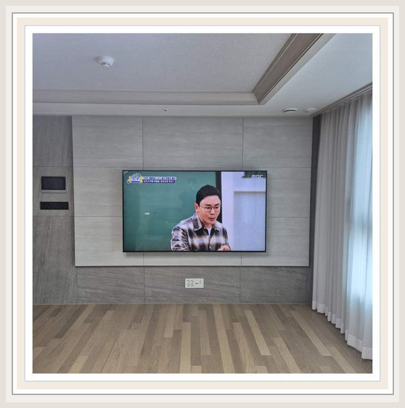 거실 가구가 배치된 상태에서 업체를 고르는 순서에 필요한 벽체·브라켓 확인을 살펴볼 수 있는 벽걸이TV 설치 참고 사진 (해당 지역 시공 사례 아님)