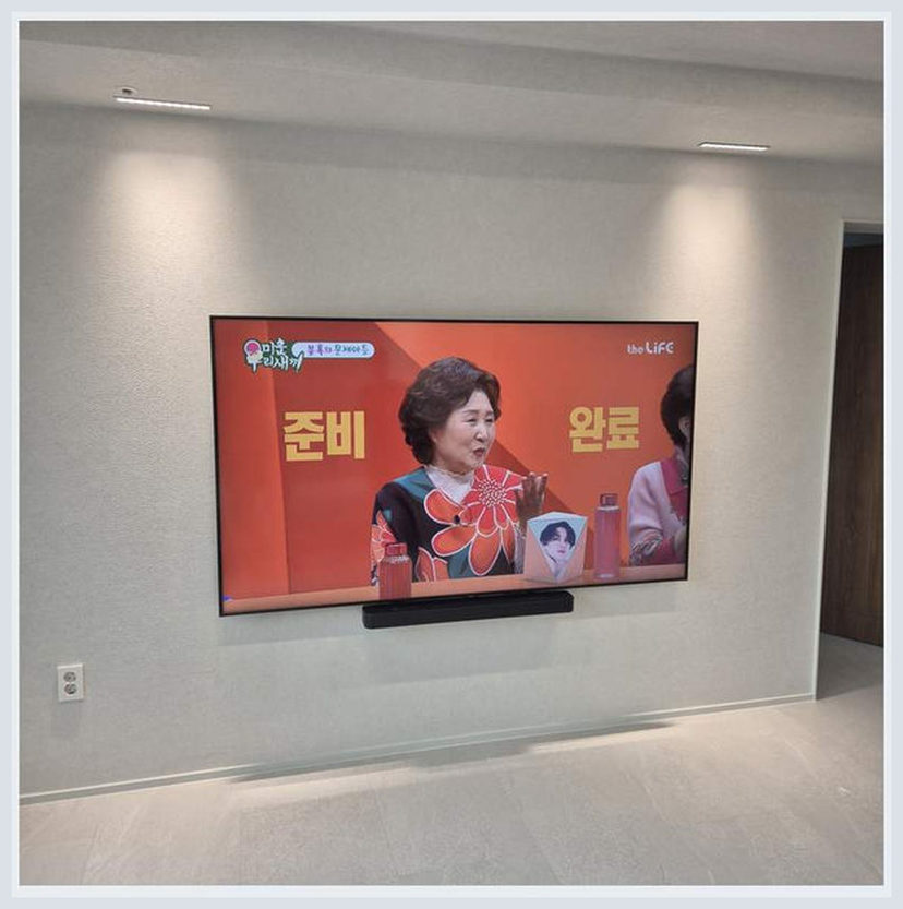가구 뒤로 감춘 케이블의 관리 문제을 살펴볼 수 있는 벽걸이TV 설치 참고 사진 (해당 지역 시공 사례 아님)